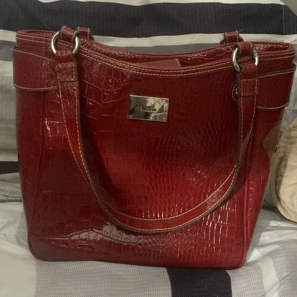 A burgundy purse with pockets
